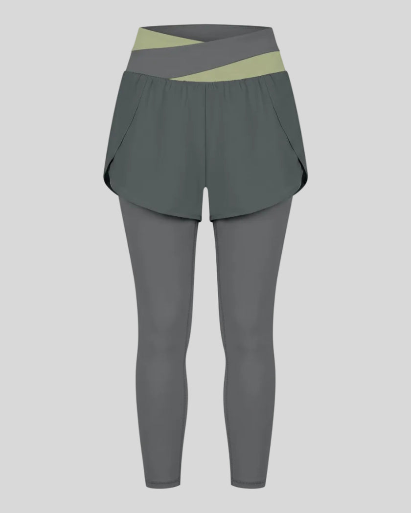 TrackLine Synergy Layered Leggings in dark gray with bean green crossover waistband and overlay shorts front view