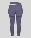 TrackLine Synergy Layered Leggings in deep purple with light purple crossover waistband and overlay shorts back view