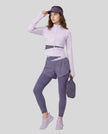 Full body front view of woman wearing TrackLine Synergy Layered Leggings in deep purple and light purple
