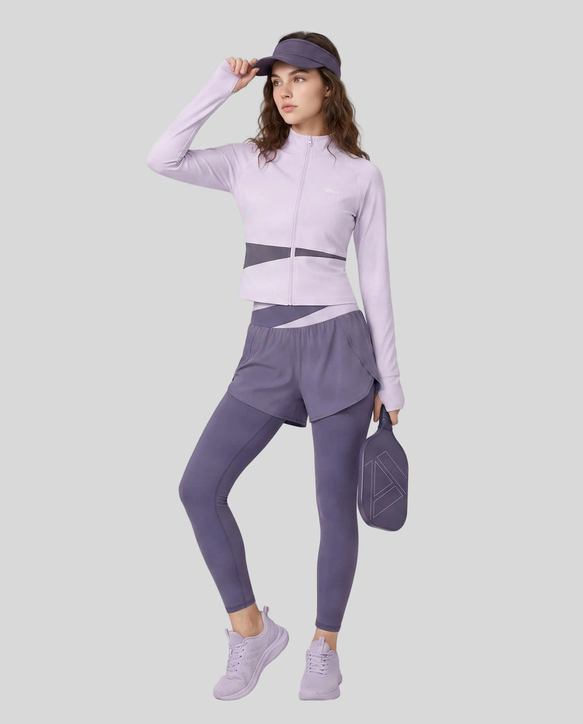 Full body front view of woman wearing TrackLine Synergy Layered Leggings in deep purple and light purple