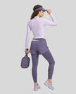 Full body back view of woman wearing TrackLine Synergy Layered Leggings in deep purple and light purple