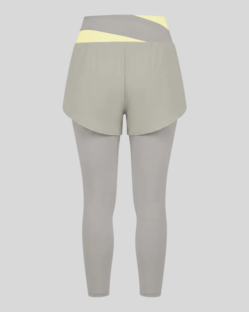 TrackLine Synergy Layered Leggings in light gray with light yellow crossover waistband and overlay shorts back view