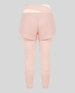 TrackLine Synergy Layered Leggings in light pink with apricot crossover waistband and overlay shorts back view