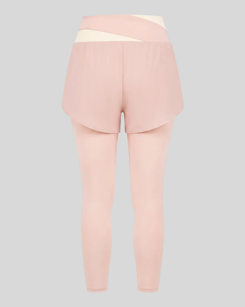 TrackLine Synergy Layered Leggings in light pink with apricot crossover waistband and overlay shorts back view
