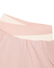 Closeup of crossover light pink and apricot waistband on TrackLine Synergy Layered Leggings