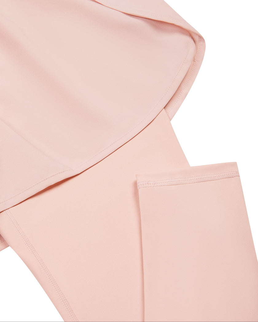 Closeup of overlay shorts and fitted legging construction on TrackLine Synergy Layered Leggings in light pink