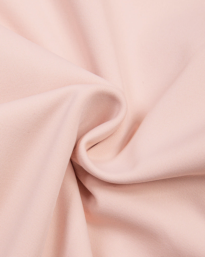 Closeup of stretch legging fabric on TrackLine Synergy Layered Leggings in light pink