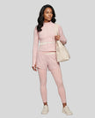 Full body front view of woman wearing TrackLine Synergy Layered Leggings in light pink and apricot