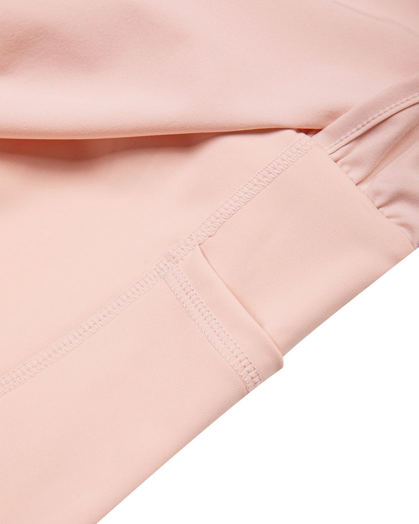 Closeup of side pocket detail on TrackLine Synergy Layered Leggings in light pink