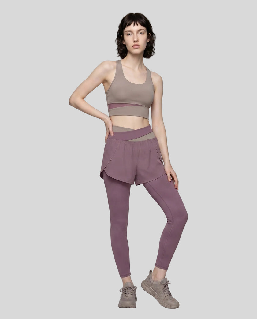 Full body front view of woman wearing TrackLine Synergy Layered Leggings in misty purple and gray purple