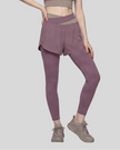 Lower body front view of woman wearing TrackLine Synergy Layered Leggings in misty purple with gray purple crossover waistband