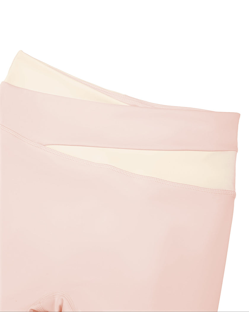 Close-up of high-rise crossover waistband on TrackLine Synergy Leggings in Light Pink and Apricot