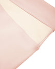 Side close-up of crossover color-block waistband construction on TrackLine Synergy Leggings in Light Pink and Apricot