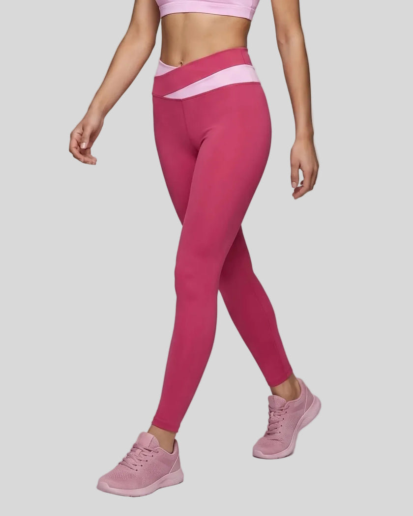 Woman wearing TrackLine Synergy Leggings in Rose Red with Pink crossover waistband, lower body front view