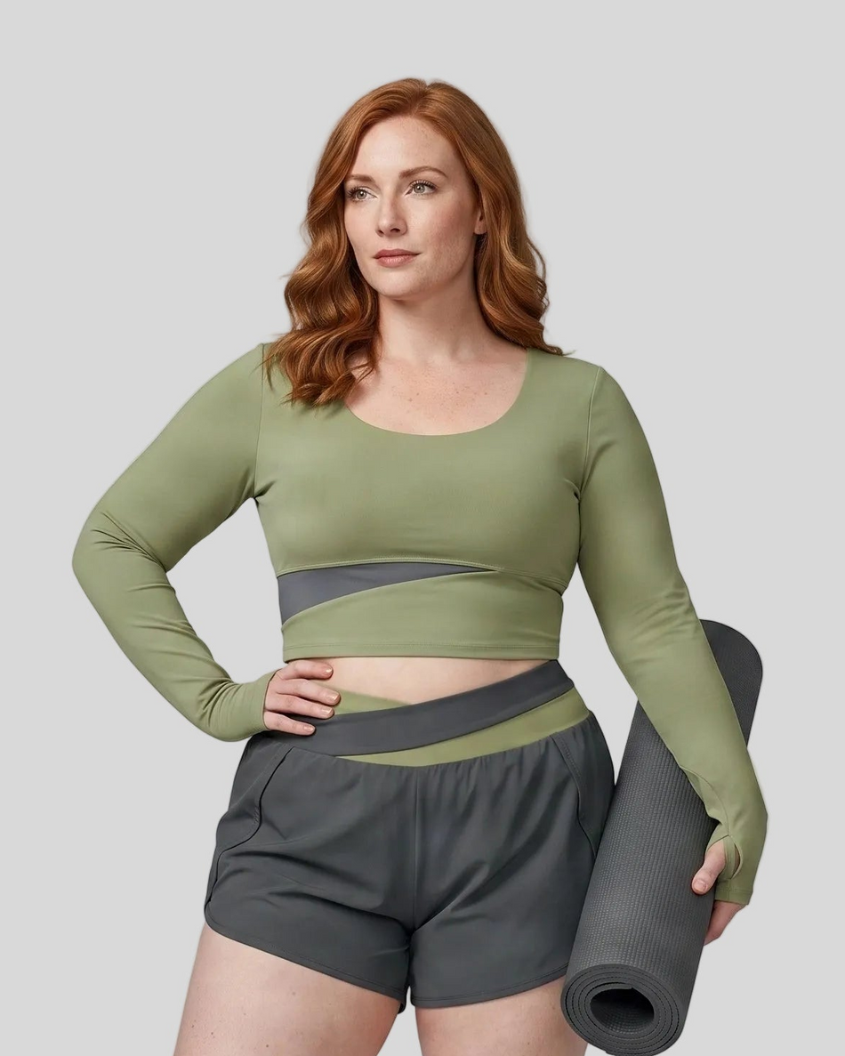 Woman wearing TrackLine Synergy Long Sleeve Top in bean green with dark gray asymmetric front detail