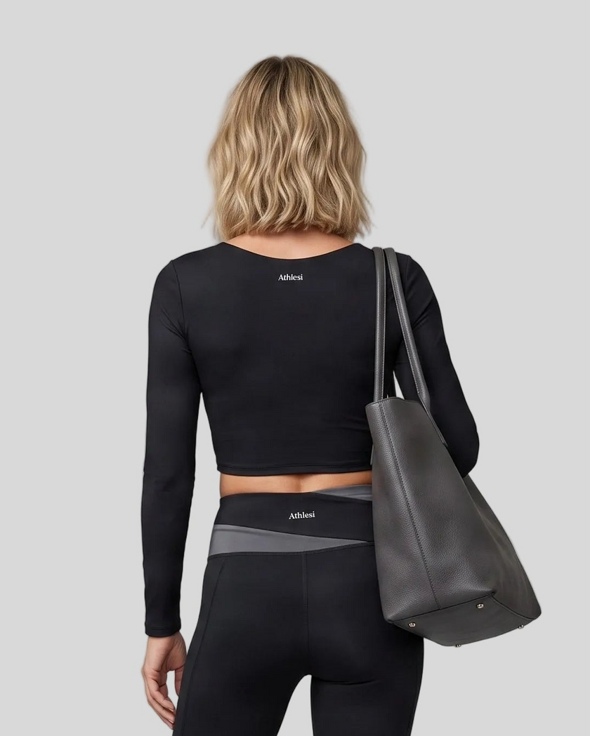 Back view of woman wearing TrackLine Synergy Long Sleeve Top in black