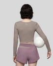 Back view of woman wearing TrackLine Synergy Long Sleeve Top in gray purple