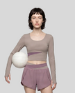 Woman wearing TrackLine Synergy Long Sleeve Top in gray purple with misty purple asymmetric front detail