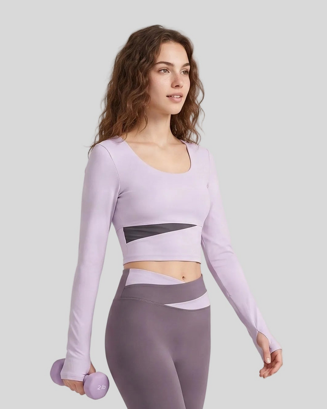 Woman wearing TrackLine Synergy Long Sleeve Top in light purple with deep purple asymmetric front detail
