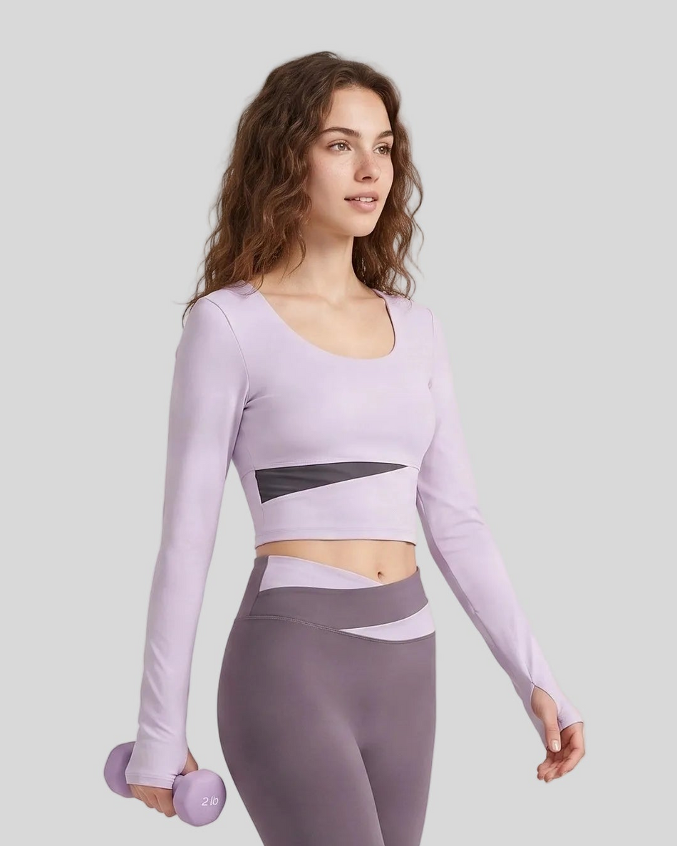 Woman wearing TrackLine Synergy Long Sleeve Top in light purple with deep purple asymmetric front detail