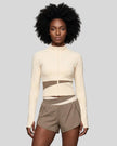 Woman wearing TrackLine Synergy Performance Jacket in Apricot with Khaki panel, front view