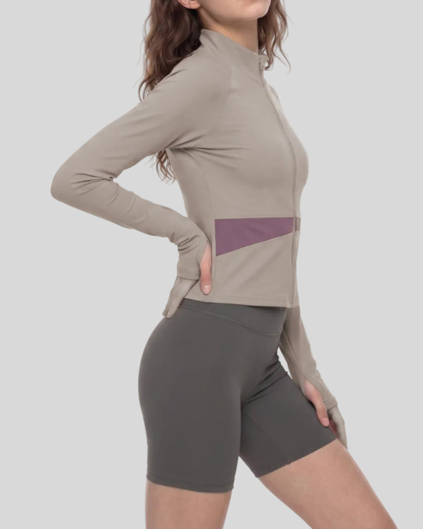 Woman wearing TrackLine Synergy Performance Jacket in Gray Purple with Misty Purple panel, mid body side angle view
