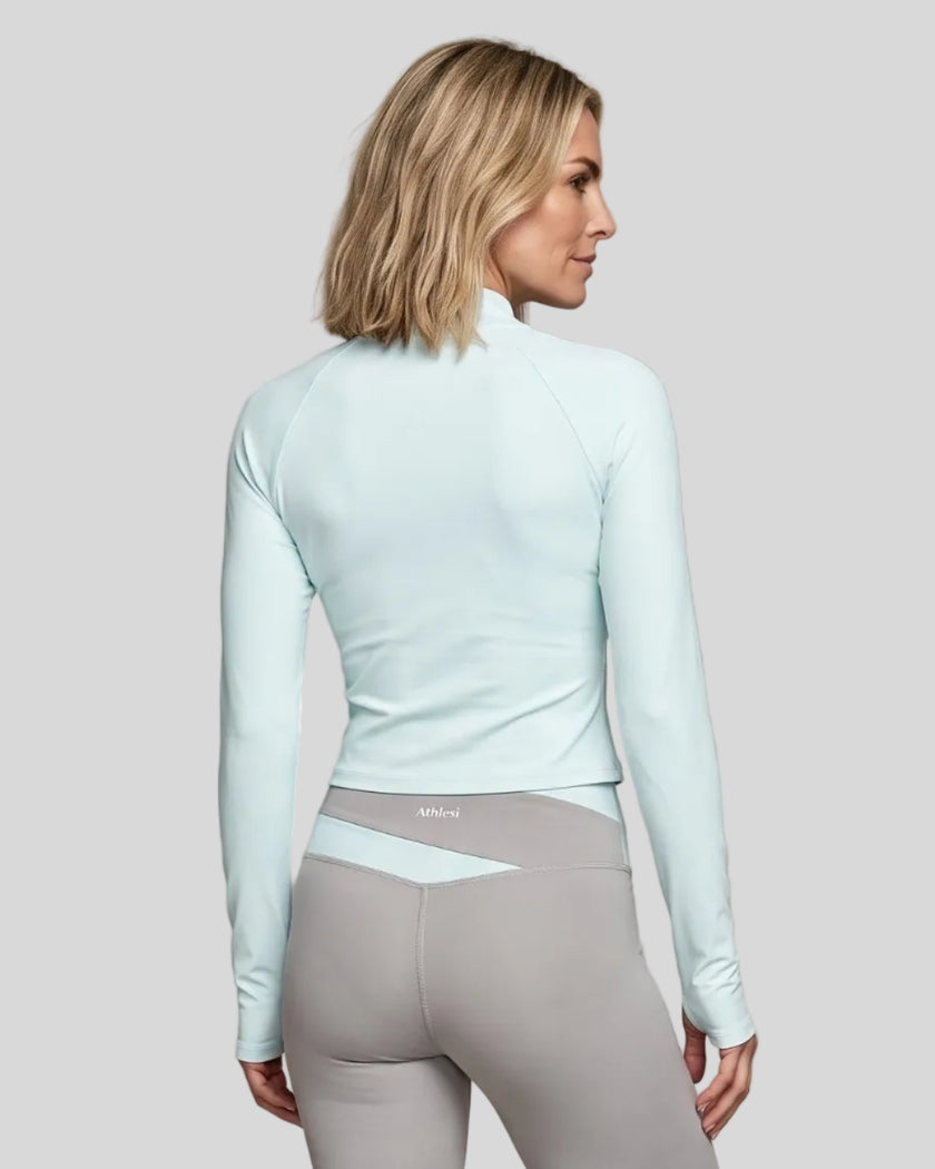 Woman wearing TrackLine Synergy Performance Jacket in Light Blue, back view