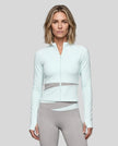 Woman wearing TrackLine Synergy Performance Jacket in Light Blue with Light Gray panel, front view