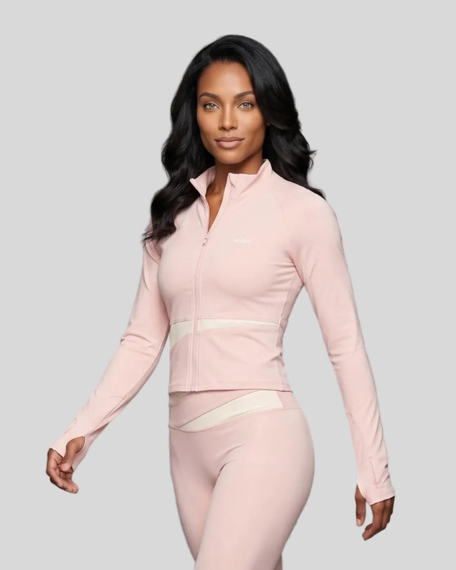 Woman wearing TrackLine Synergy Performance Jacket in Light Pink with Apricot panel, angled front view