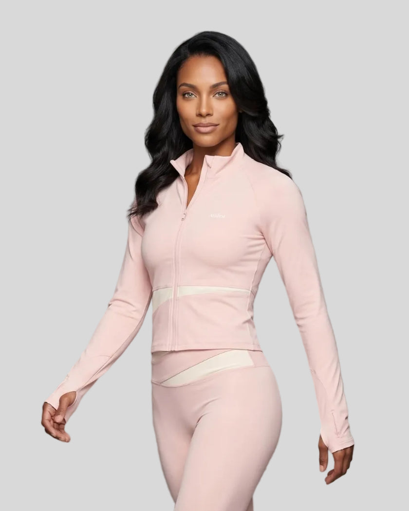 Woman wearing TrackLine Synergy Performance Jacket in Light Pink with Apricot panel, angled front view