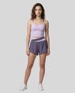 Woman wearing TrackLine Synergy Performance Shorts in Deep Purple with Light Purple waistband, front view