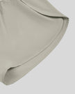 Close-up of curved outer hem on TrackLine Synergy Performance Shorts in Light Gray