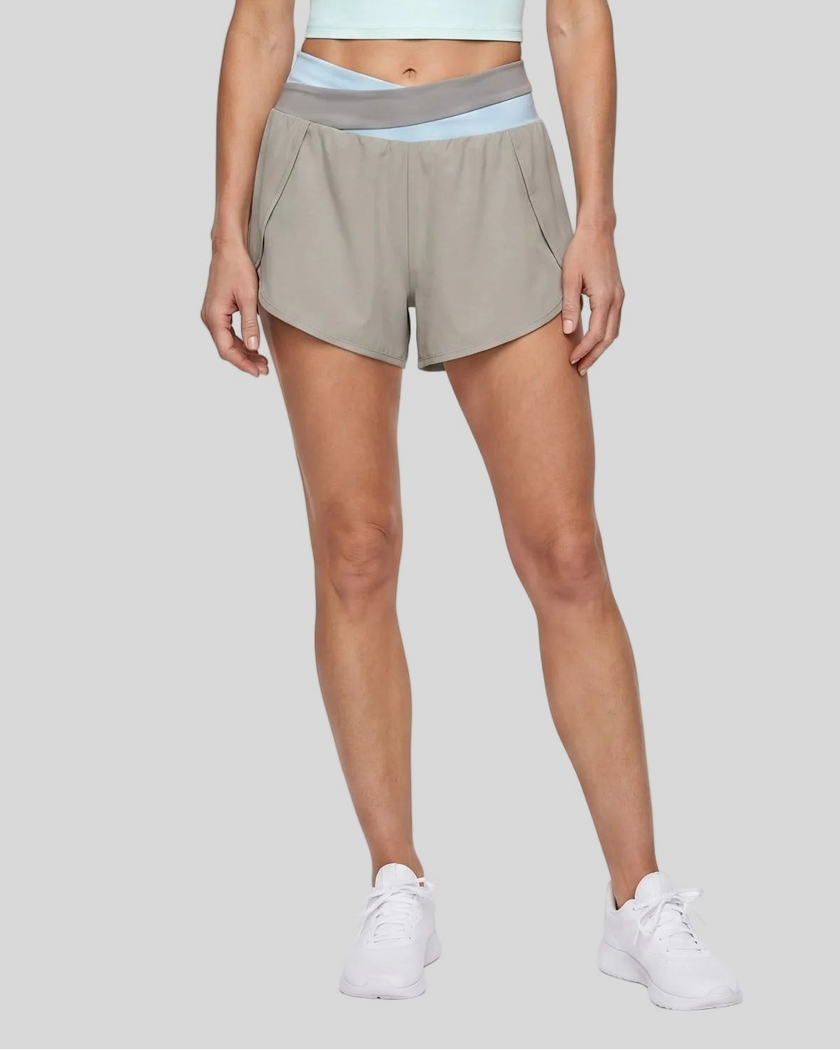 Woman wearing TrackLine Synergy Performance Shorts in Light Gray with Light Blue waistband, lower body front view