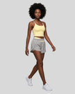Woman wearing TrackLine Synergy Performance Shorts in Light Gray with Light Yellow waistband, front angle view