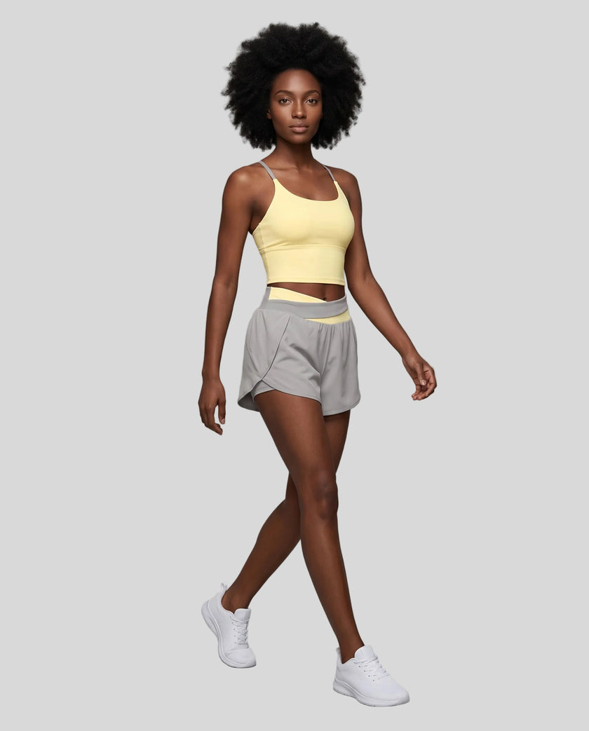 Woman wearing TrackLine Synergy Performance Shorts in Light Gray with Light Yellow waistband, front angle view