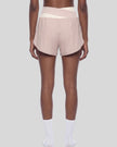 TrackLine Synergy Performance Shorts in Light Pink with Apricot color-block waistband, mid body back view