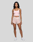 Woman wearing TrackLine Synergy Performance Shorts in Light Pink with Apricot waistband, front view