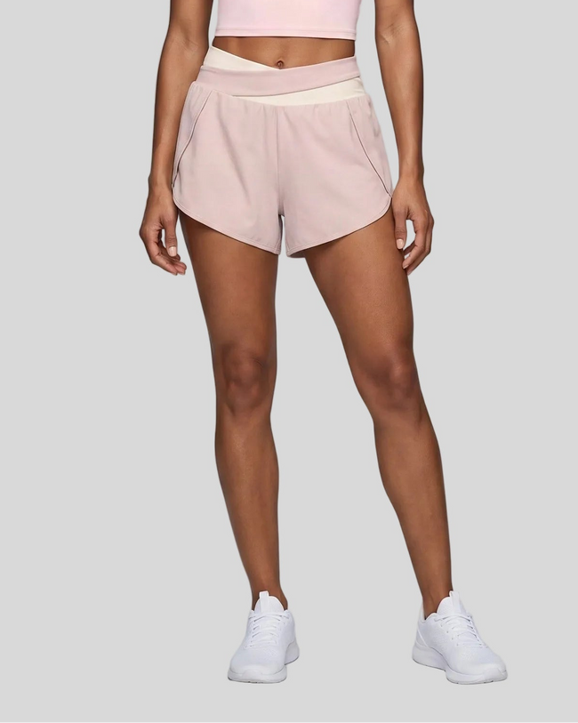 TrackLine Synergy Performance Shorts in Light Pink with Apricot color-block waistband, lower body front view