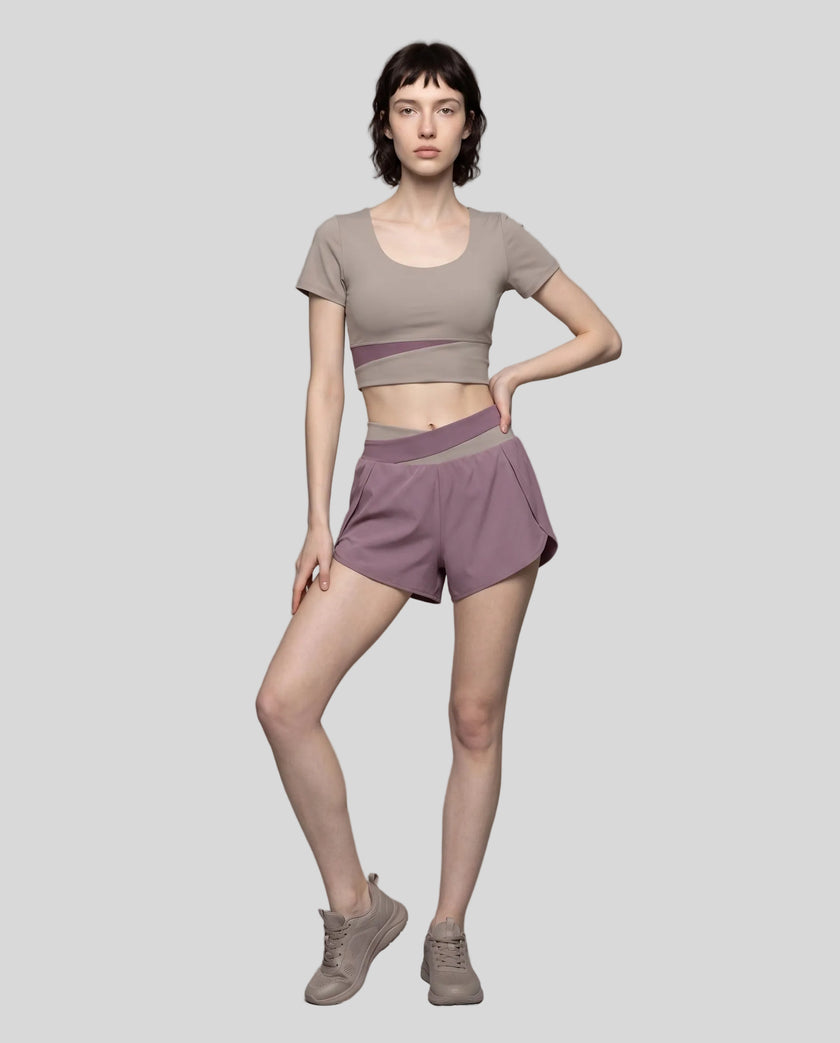 Woman wearing TrackLine Synergy Performance Shorts in Misty Purple with Gray Purple waistband, front view