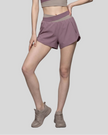 Woman wearing TrackLine Synergy Performance Shorts in Misty Purple with Gray Purple waistband, lower body front view
