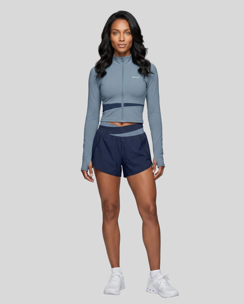 Woman wearing TrackLine Synergy Performance Shorts in Navy Blue with Gray Blue waistband, front view