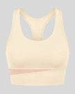 TrackLine Synergy Racerback Sports Bra in Apricot with Light Pink color-block detail, 3d front view