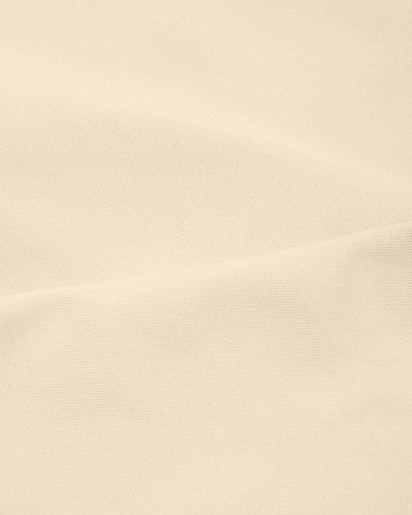 Close-up of stretch fabric on TrackLine Synergy Racerback Sports Bra in Apricot