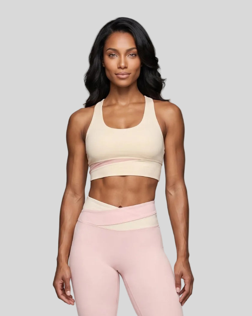 Woman wearing TrackLine Synergy Racerback Sports Bra in Apricot with Light Pink detail, front view