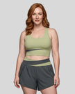 Woman wearing TrackLine Synergy Racerback Sports Bra in Bean Green with Dark Gray detail, front view