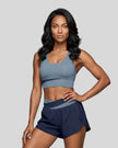 Woman wearing TrackLine Synergy Racerback Sports Bra in Gray Blue with Navy Blue detail, front view