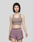 Woman wearing TrackLine Synergy Racerback Sports Bra in Gray Purple with Misty Purple detail, front view