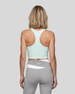 Woman wearing TrackLine Synergy Racerback Sports Bra in Light Blue, racerback view