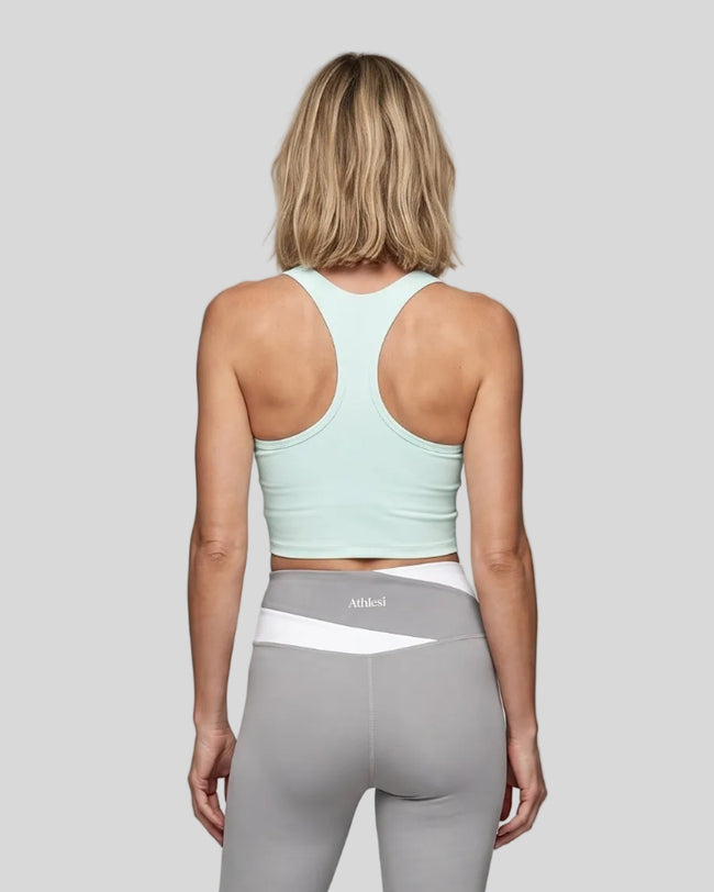 Woman wearing TrackLine Synergy Racerback Sports Bra in Light Blue, racerback view