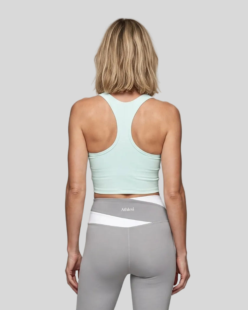 Woman wearing TrackLine Synergy Racerback Sports Bra in Light Blue, racerback view